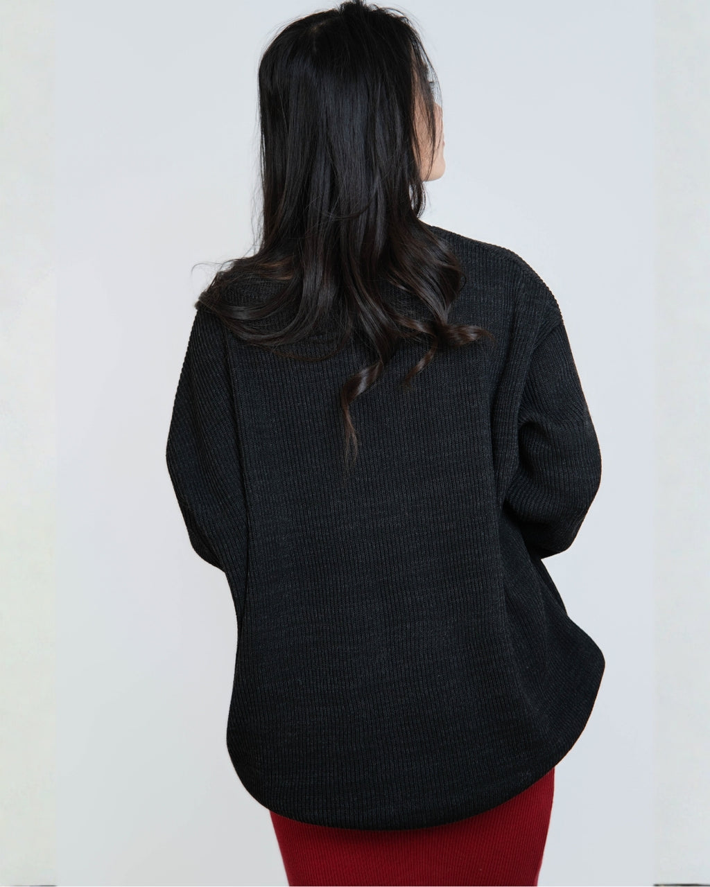 woman wearing an oversized crew neck sweater in Coal black by The Knit House LA.