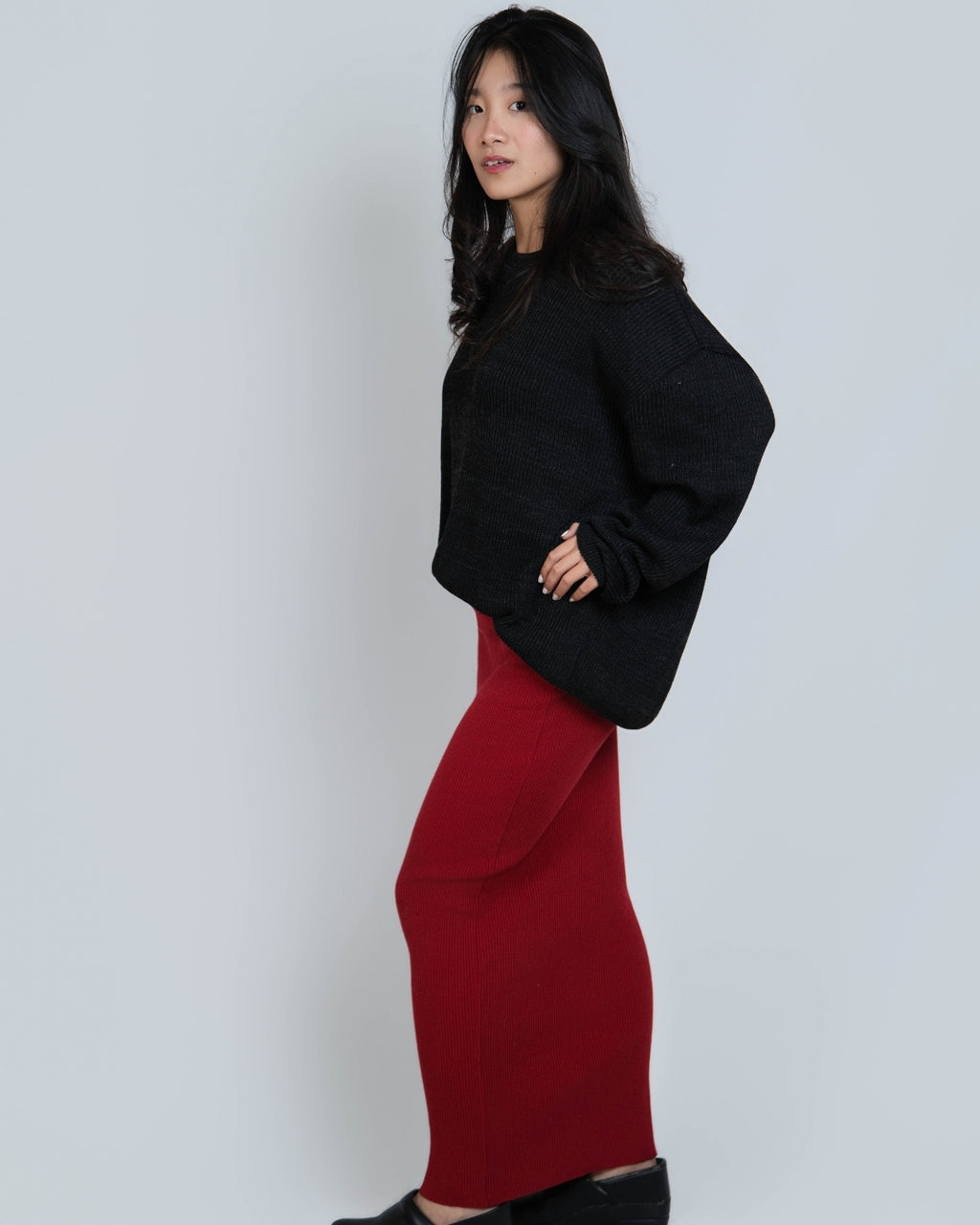 woman wearing an oversized crew neck sweater in Coal black by The Knit House LA.