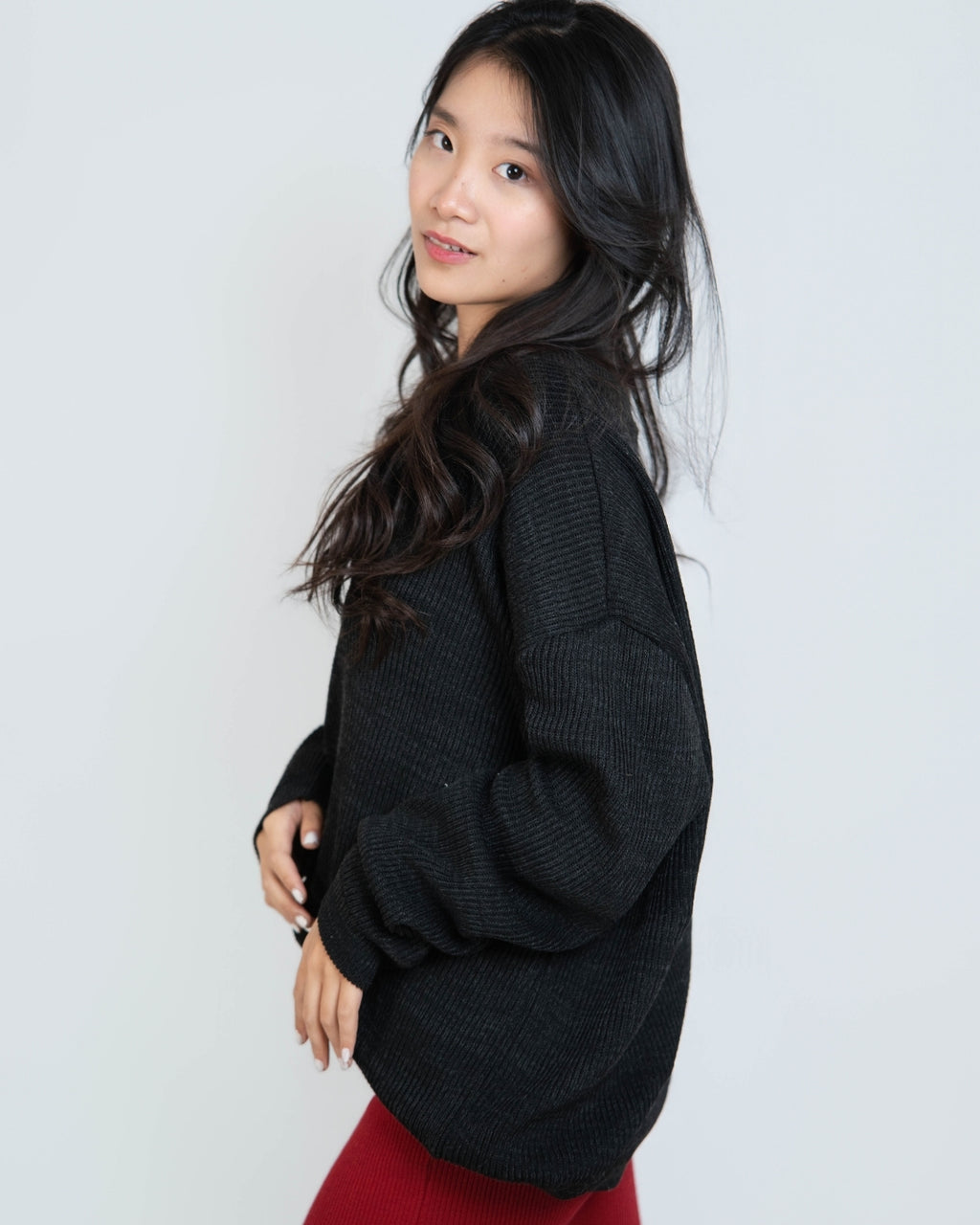 woman wearing an oversized crew neck sweater in Coal black by The Knit House LA.