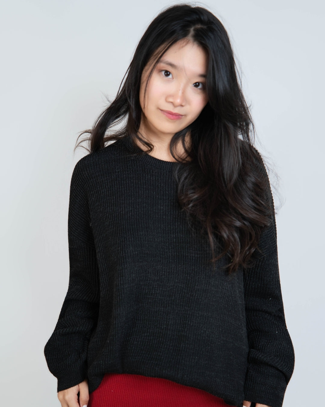 woman wearing an oversized crew neck sweater in Coal black by The Knit House LA.