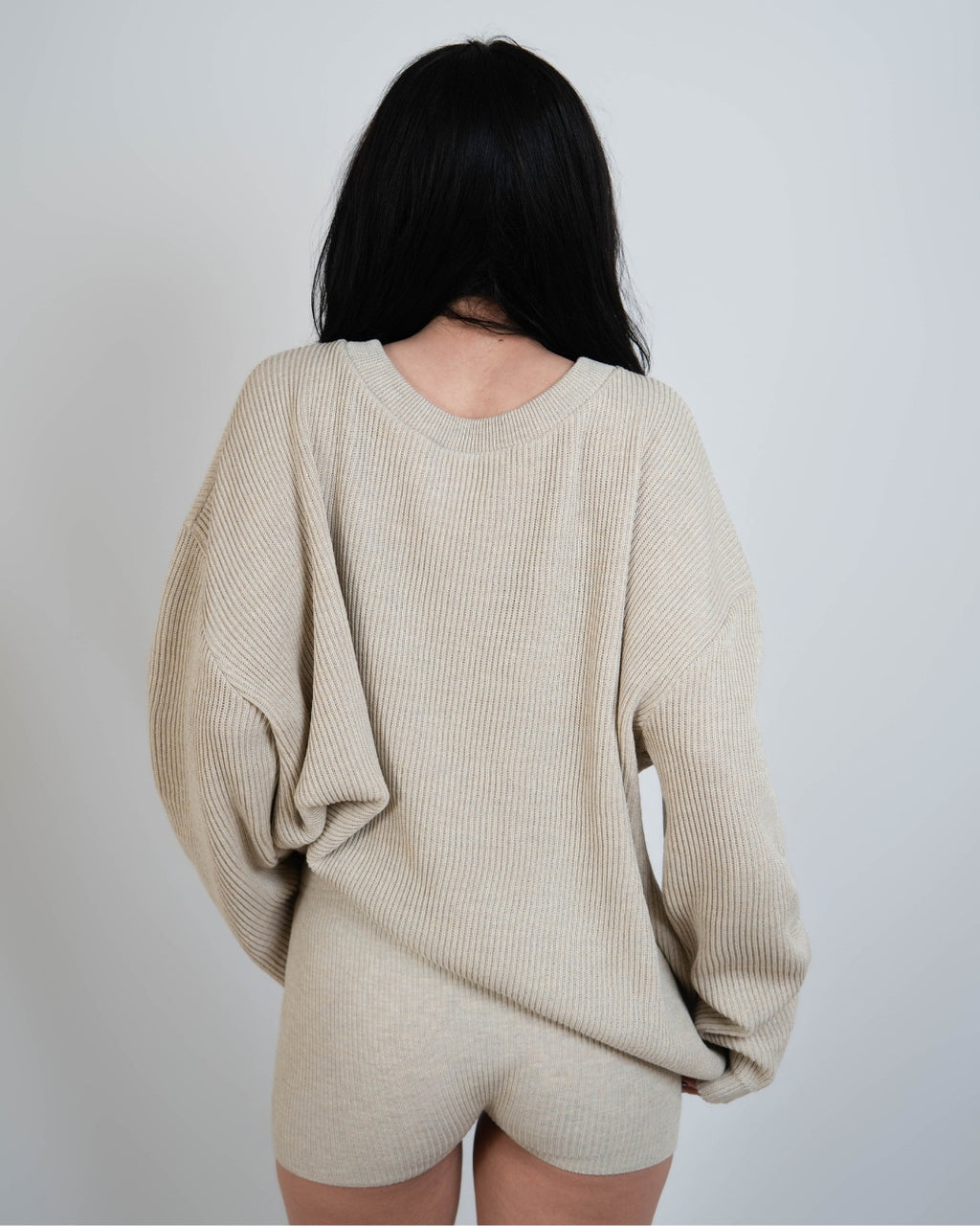 woman wearing rib knit oversized crew neck sweater in Neutral beige by The Knit House LA.