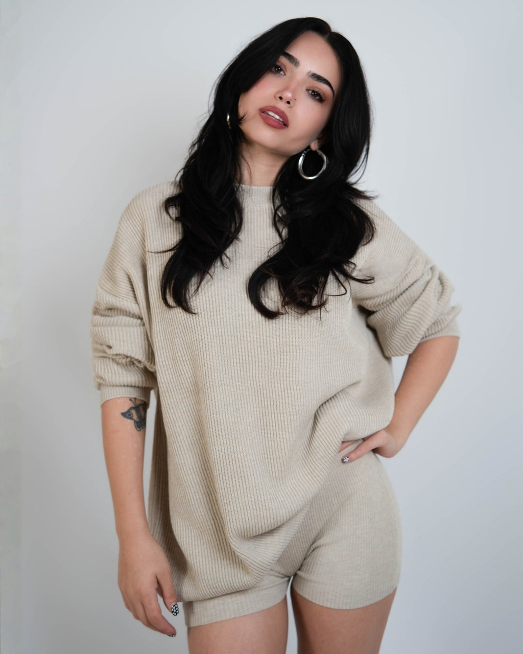 woman wearing rib knit oversized crew neck sweater in Neutral beige by The Knit House LA.