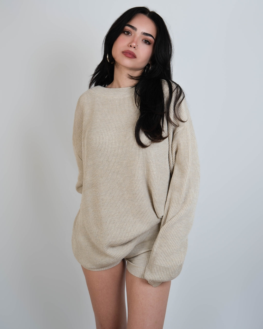 woman wearing rib knit oversized crew neck sweater in Neutral beige by The Knit House LA.