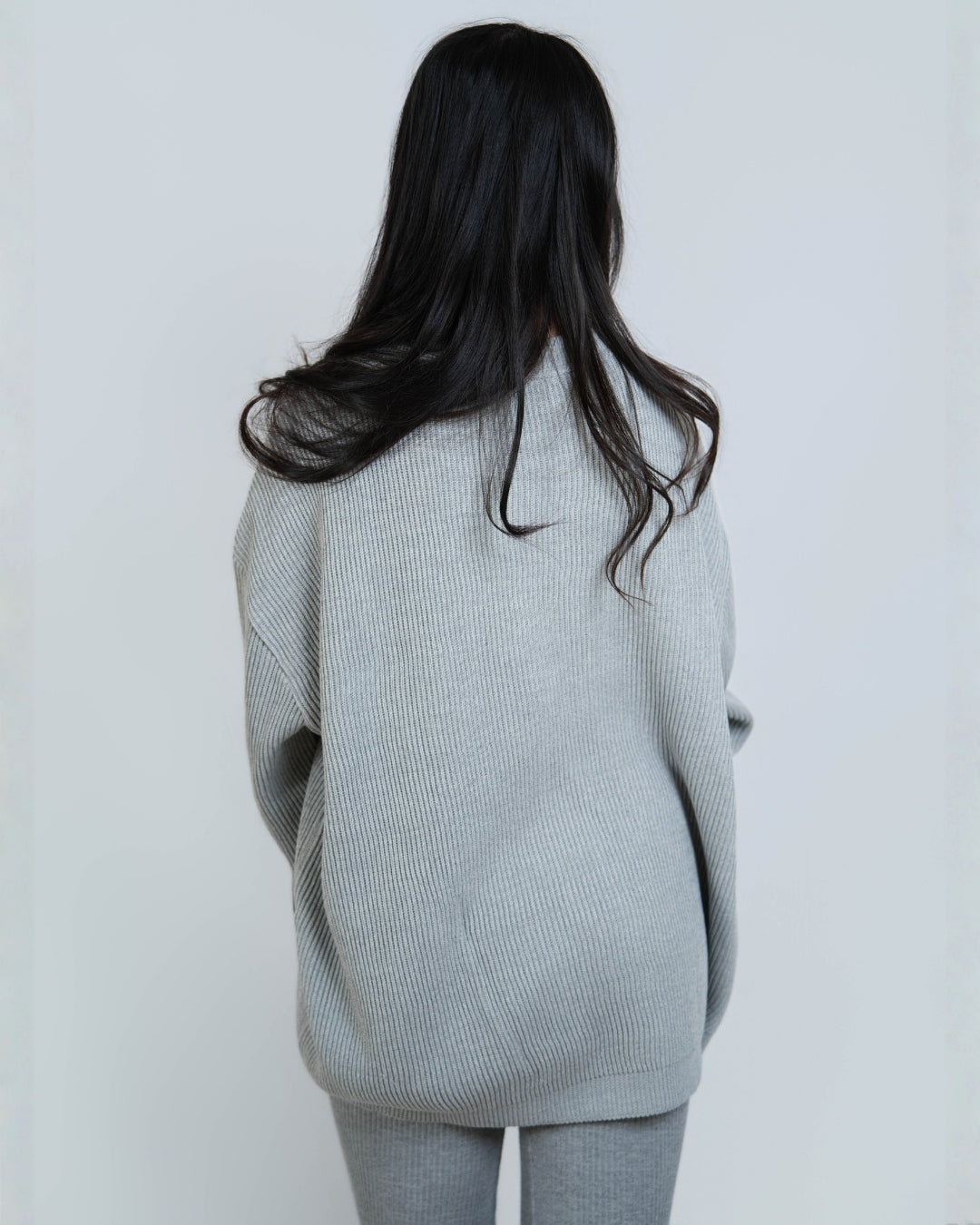 Woman wearing rib knit oversized crew neck sweater in Slate grey by The Knit House LA.