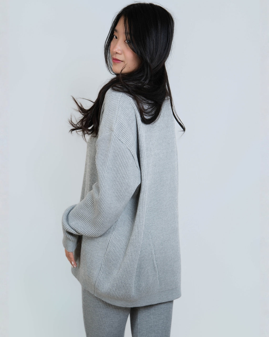 Woman wearing rib knit oversized crew neck sweater in Slate grey by The Knit House LA.