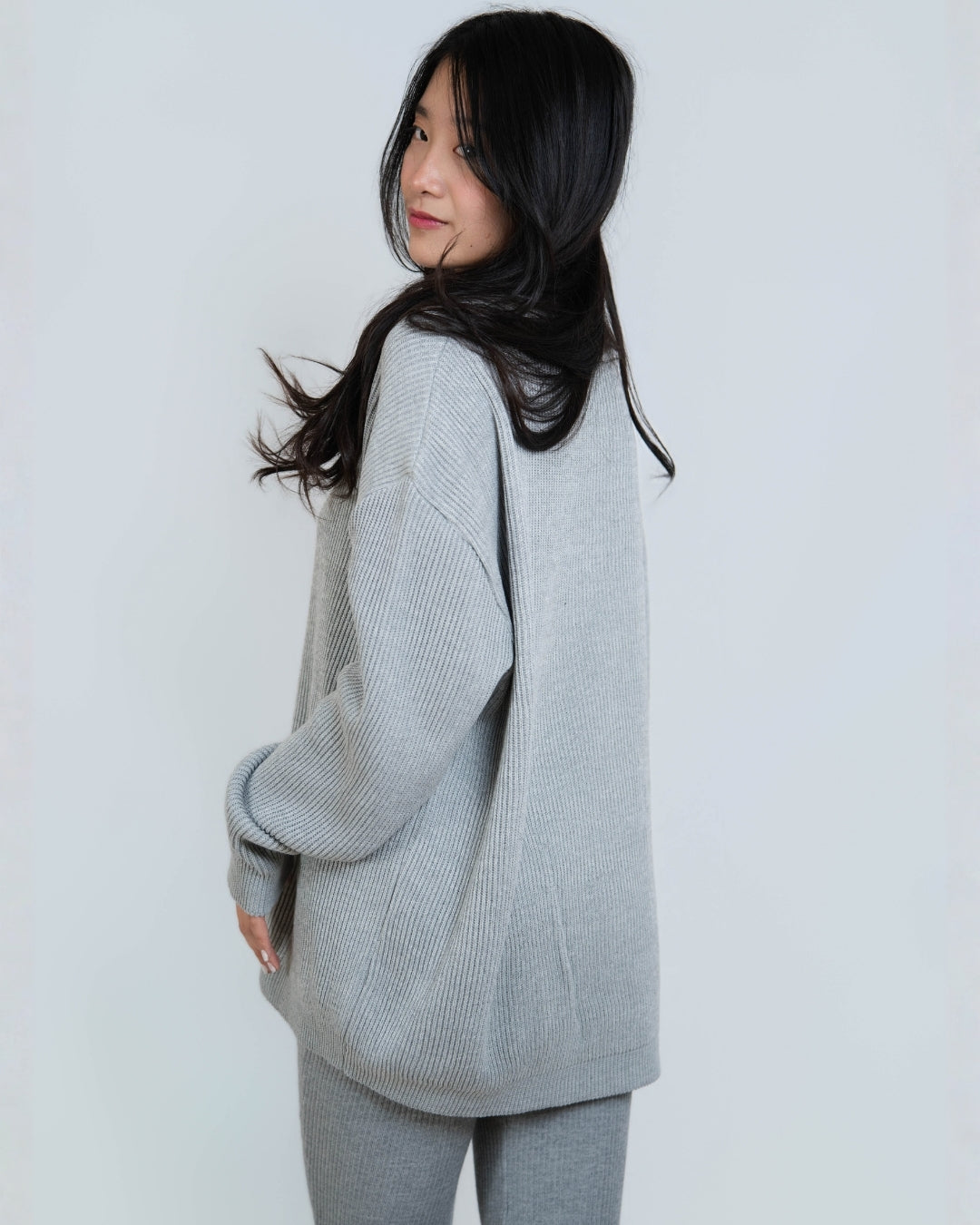 Woman wearing rib knit oversized crew neck sweater in Slate grey by The Knit House LA.